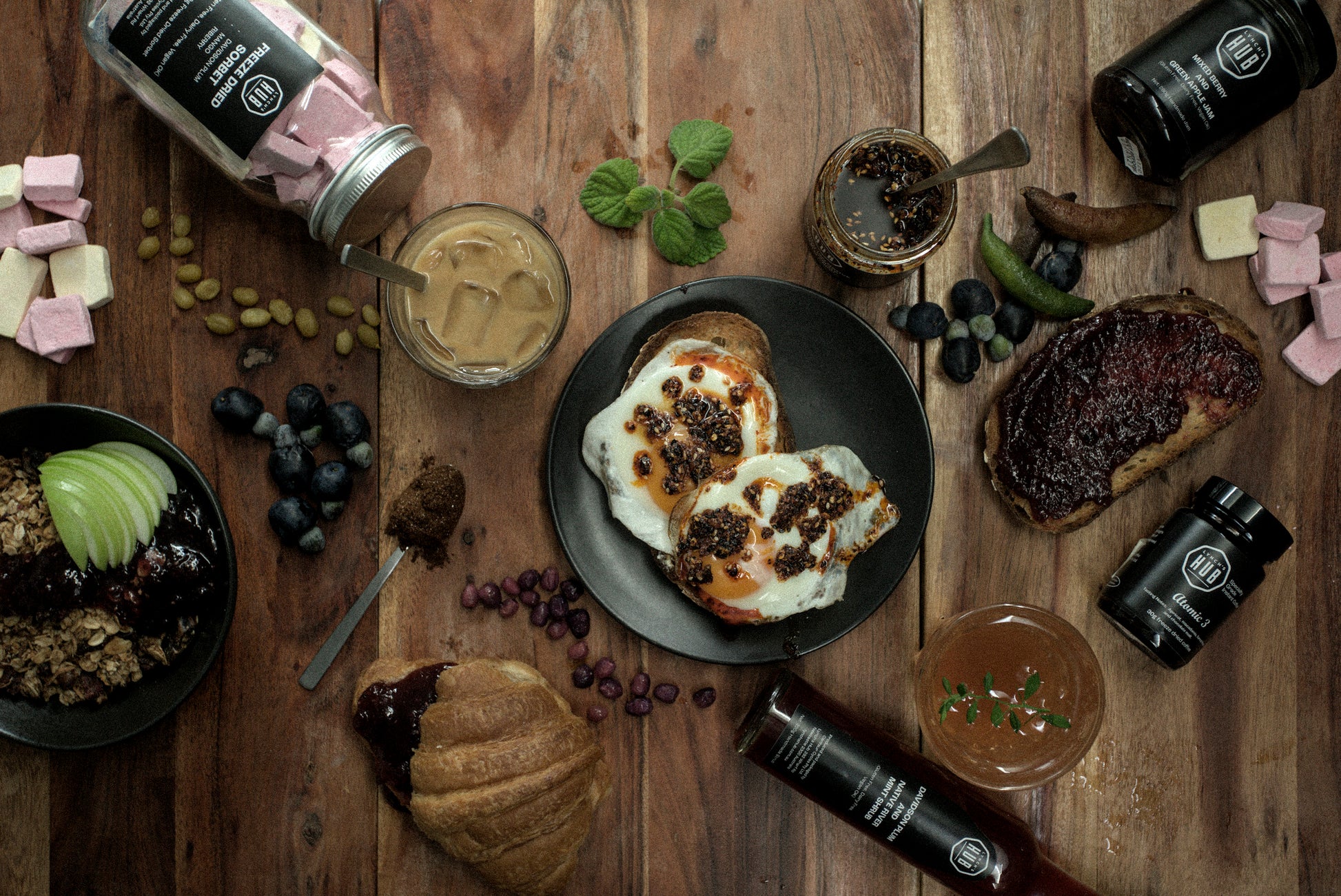 A spread of Lynch's Pantry food products on a table including jams, chilli oil, coffee, and freeze-dried gelato.